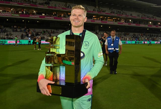 <p>Sam Billingham holds the men’s Hundred trophy at Lord’s</p>